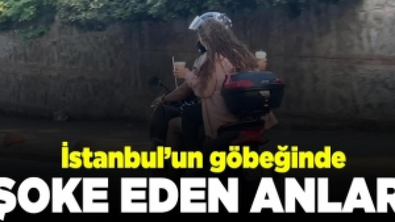 Elinde kahve bardaklarıyla motosiklette yolculuk kamerada