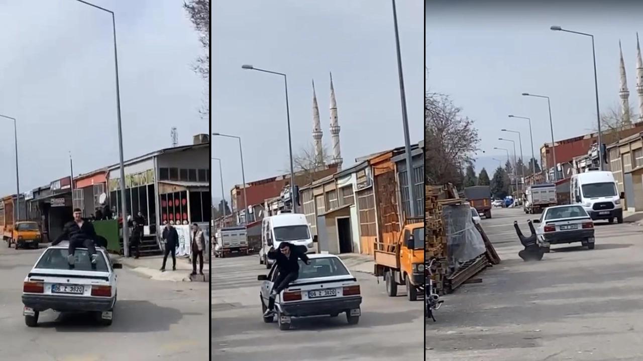 Otomobilin tavanında tehlikeli yolculuk kötü bitti: Kendini saniyeler sonra yerde buldu