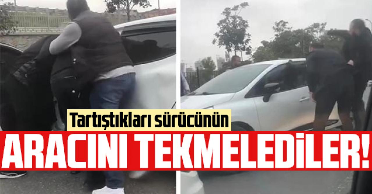 Tartıştıkları kişinin aracını tekmelediler